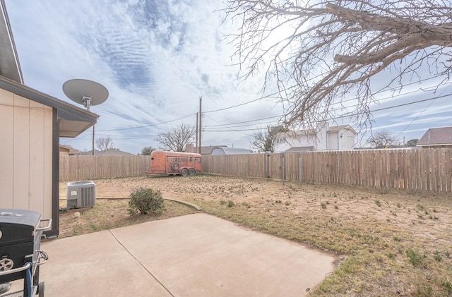 view of yard featuring a fenced backyard, cooling unit, and a patio