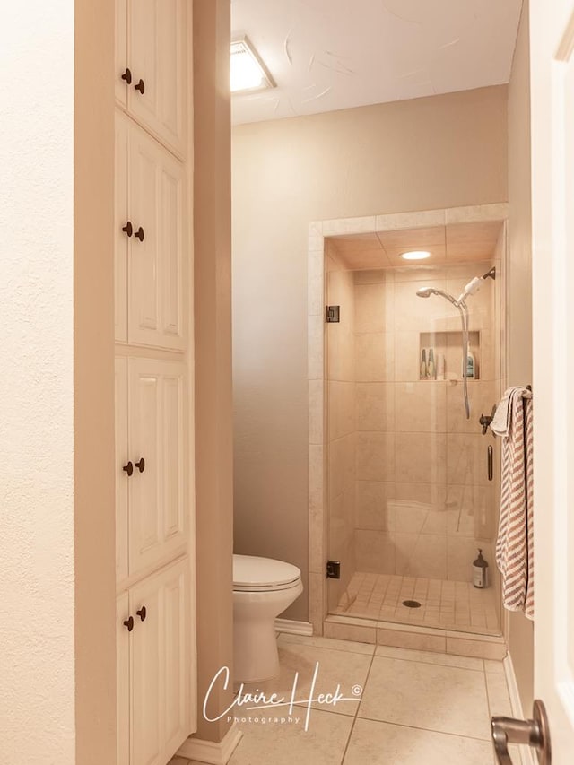 4300 Tumbleweed Trl, Midland, TX 79707 - bathroom with toilet, a shower stall, tile patterned floors, and a closet
