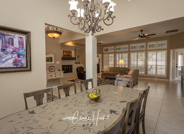 4300 Tumbleweed Trl, Midland, TX 79707 - dining room with light tile patterned floors, decorative columns, a ceiling fan, a chandelier, and a high ceiling