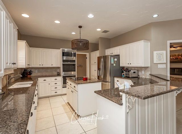 4300 Tumbleweed Trl, Midland, TX 79707 - kitchen featuring appliances with stainless steel finishes, a sink, light tile patterned floors, decorative backsplash, and recessed lighting