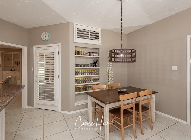 4300 Tumbleweed Trl, Midland, TX 79707 - dining space featuring light tile patterned floors, baseboards, and built in shelves