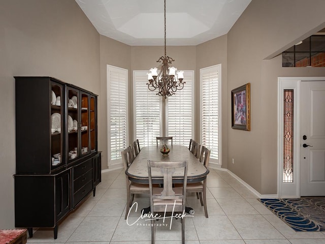 4300 Tumbleweed Trl, Midland, TX 79707 - dining room featuring a chandelier, light tile patterned flooring, baseboards, and a raised ceiling