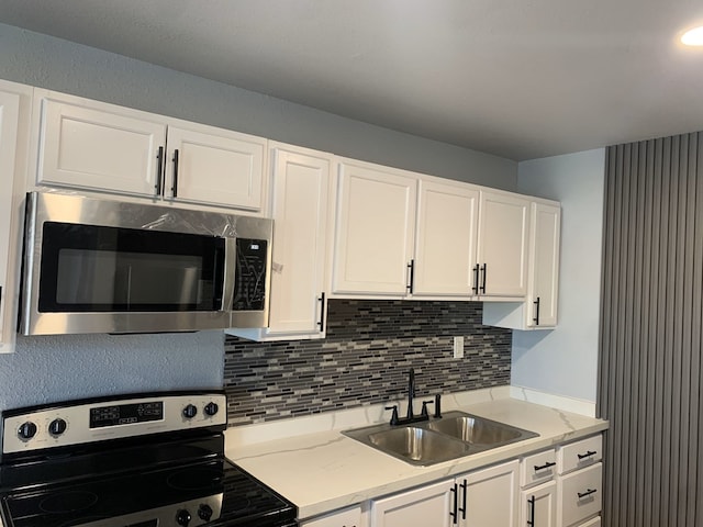 kitchen featuring sink, white cabinets, and appliances with stainless steel finishes