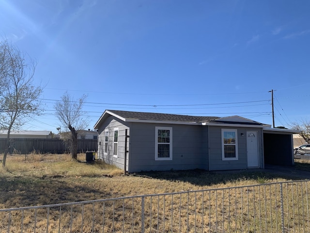 view of front of home with central AC and a front yard