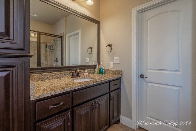 bathroom with vanity and a shower with shower door