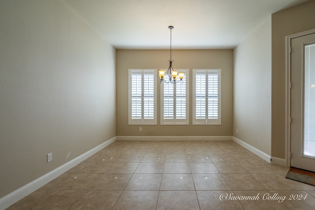 unfurnished dining area featuring light tile patterned floors and a notable chandelier