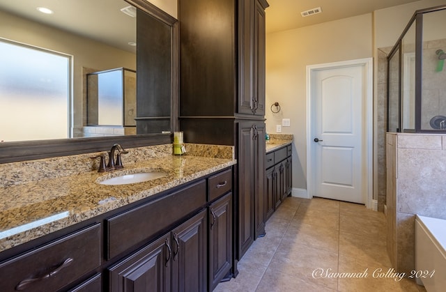 bathroom featuring tile patterned flooring, vanity, and independent shower and bath