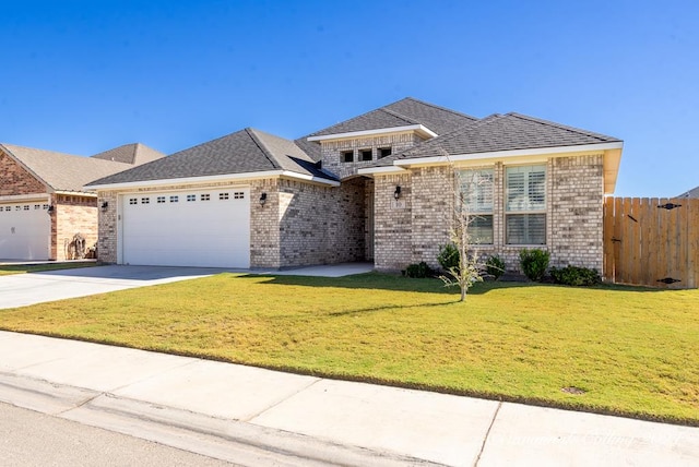 view of front of home featuring a front yard and a garage