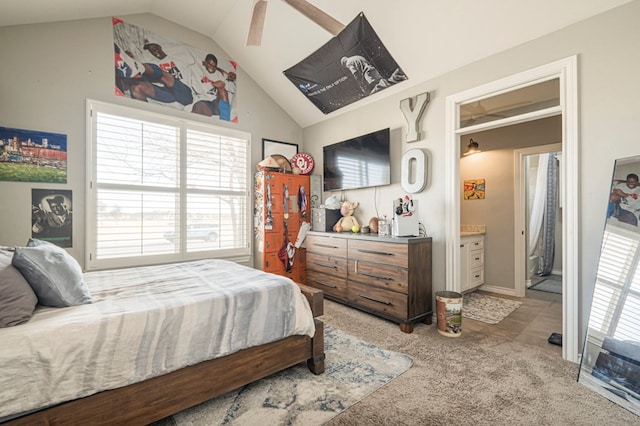 carpeted bedroom featuring vaulted ceiling, ceiling fan, and ensuite bathroom