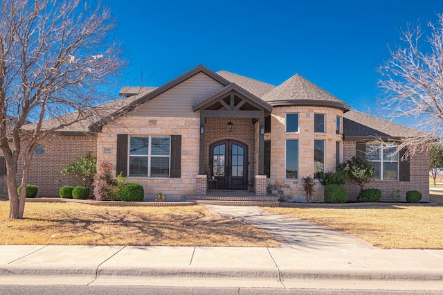 view of front of property with a front lawn and french doors