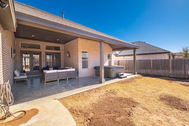 back of house with a hot tub, outdoor lounge area, french doors, and a patio area