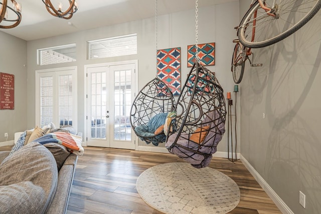 sitting room featuring wood-type flooring and french doors