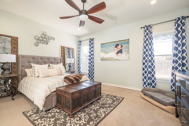 carpeted bedroom with multiple windows and ceiling fan