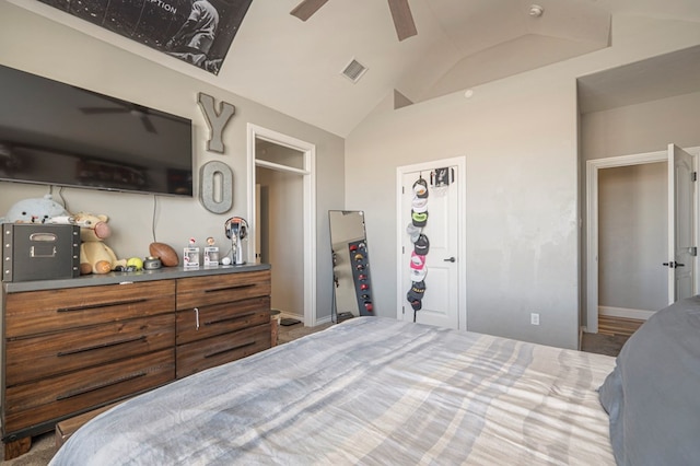 bedroom with lofted ceiling, ceiling fan, and a closet