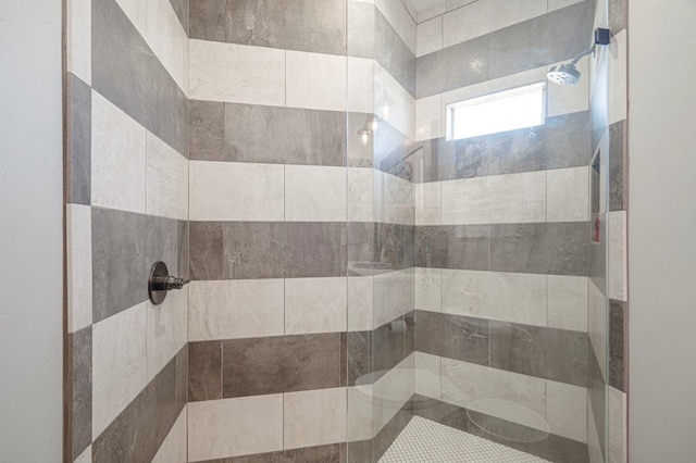 bathroom with a tile shower