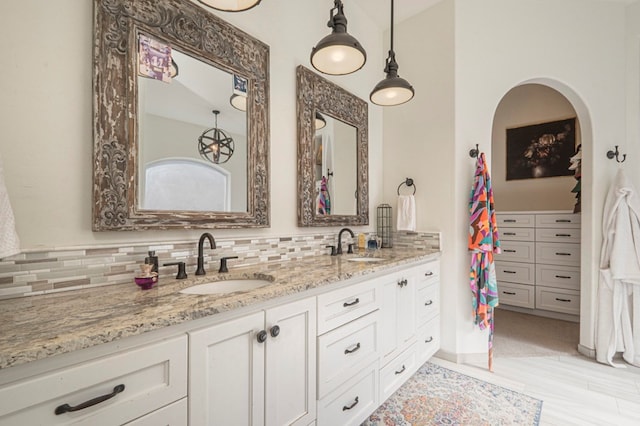 bathroom with vanity and decorative backsplash