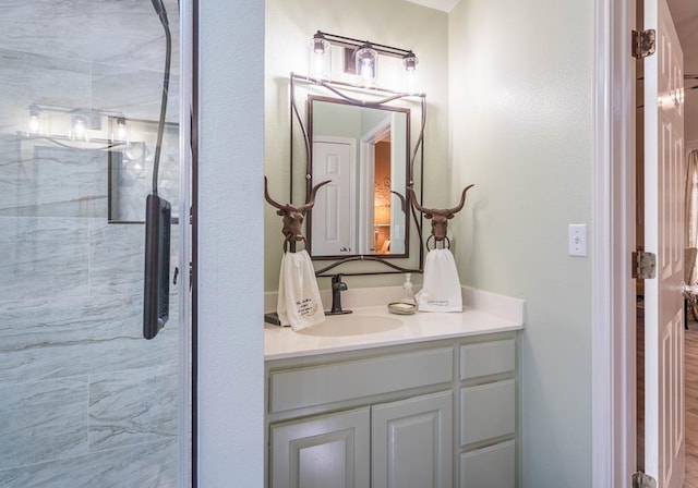 full bathroom featuring a shower stall and vanity