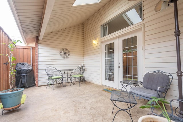 view of patio featuring french doors, a grill, and fence