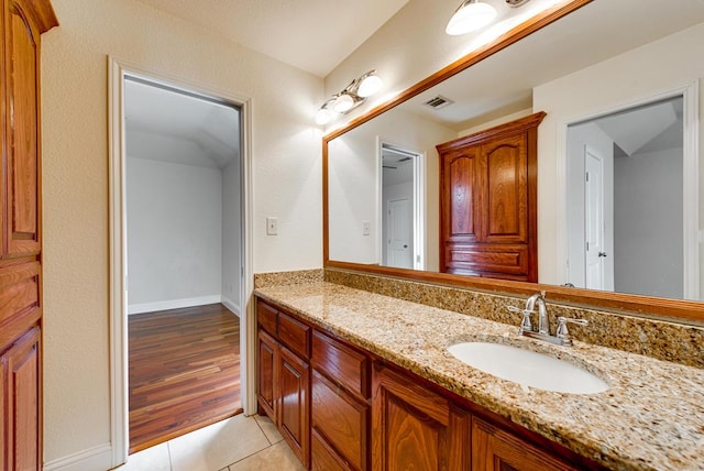 bathroom with tile patterned flooring, visible vents, vanity, and baseboards