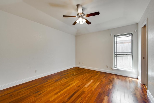 empty room with wood-type flooring, baseboards, and ceiling fan