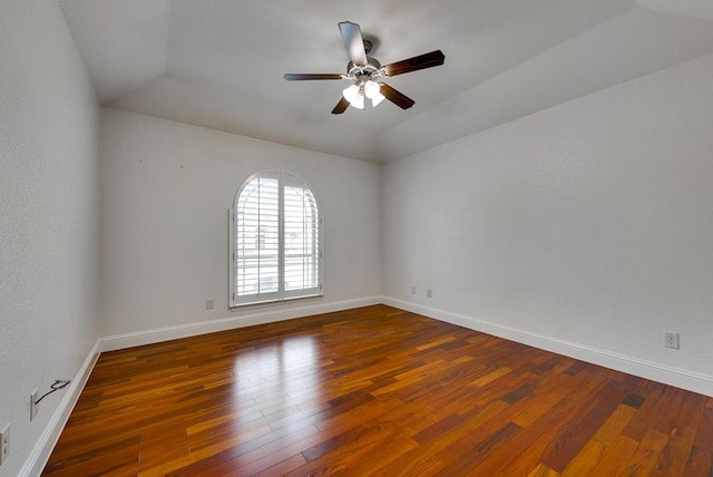 spare room with ceiling fan, hardwood / wood-style flooring, and baseboards