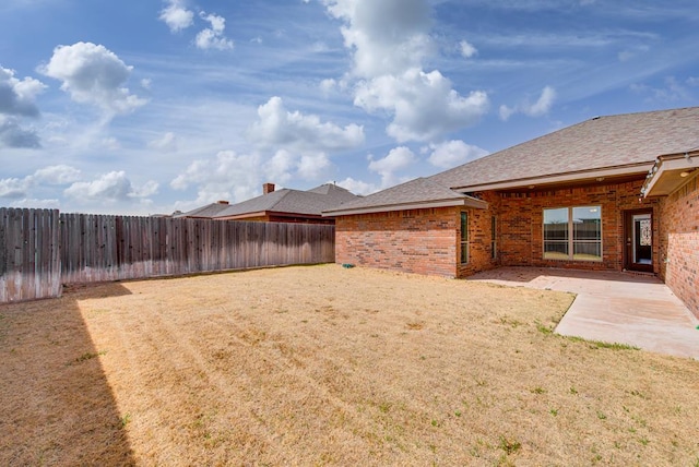 view of yard with a patio and a fenced backyard