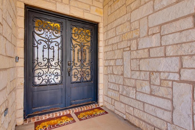 entrance to property featuring stone siding