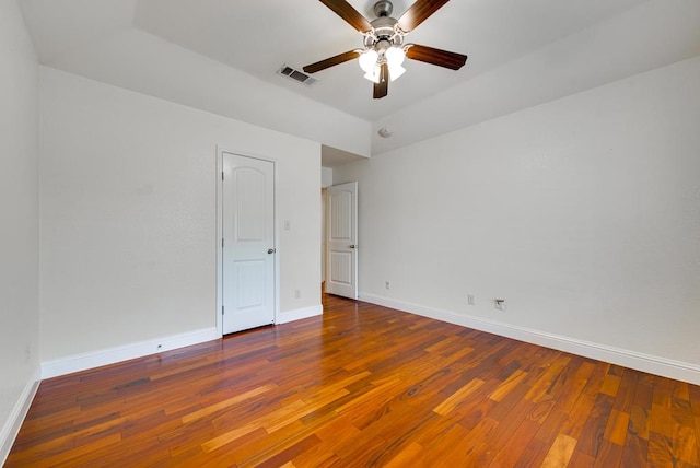 unfurnished bedroom featuring visible vents, baseboards, and hardwood / wood-style flooring