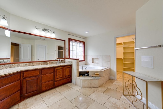 bathroom featuring a shower, tile patterned flooring, vanity, and a bath