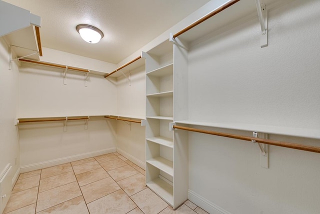 spacious closet featuring light tile patterned flooring