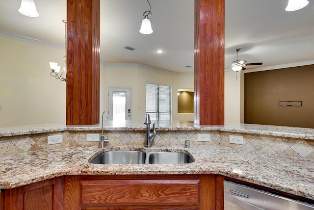 kitchen featuring brown cabinets, visible vents, stainless steel dishwasher, ornamental molding, and a sink