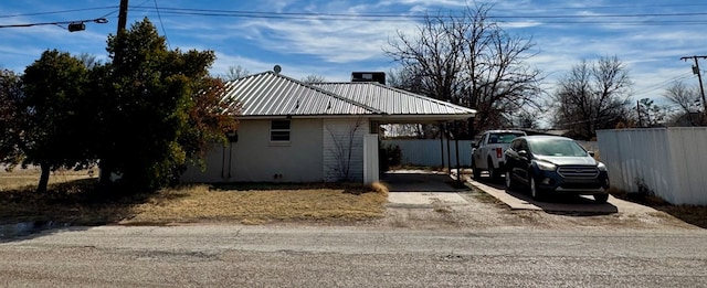 view of property exterior with a carport