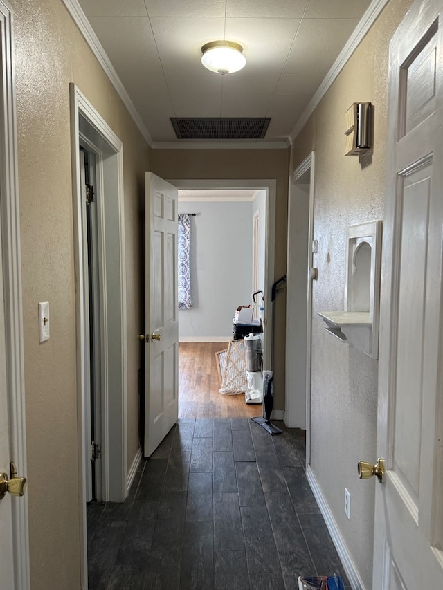 corridor featuring ornamental molding and dark hardwood / wood-style flooring