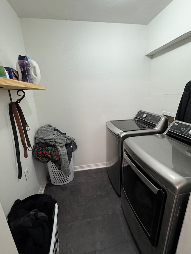 clothes washing area with washing machine and clothes dryer