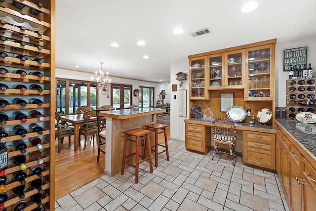 office area with light hardwood / wood-style floors and an inviting chandelier