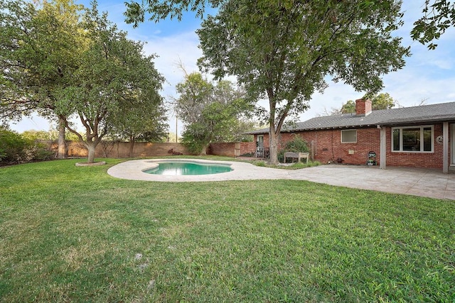 view of yard with a fenced in pool and a patio area