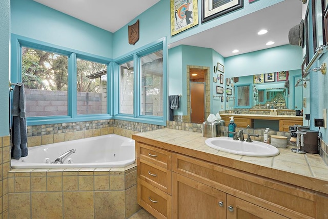 bathroom featuring shower with separate bathtub and vanity