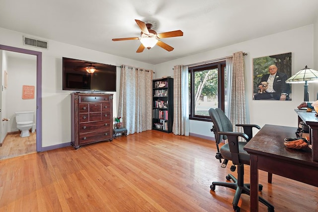 home office featuring light wood-type flooring and ceiling fan