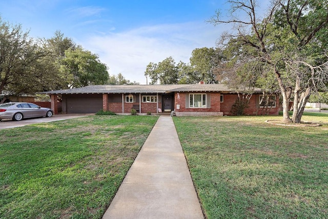 ranch-style home featuring a garage and a front lawn