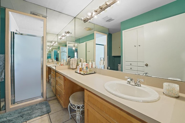 bathroom featuring toilet, a shower with door, vanity, and tile patterned flooring