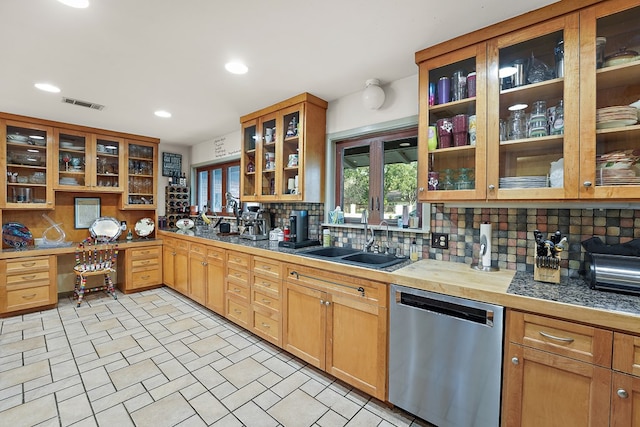 kitchen with dishwasher, backsplash, and sink