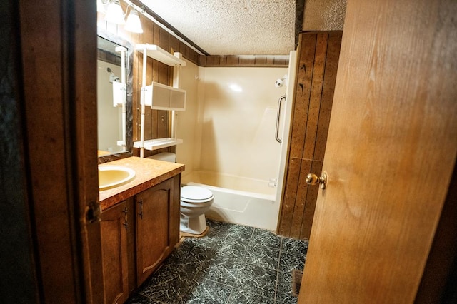 full bathroom with vanity, a textured ceiling, washtub / shower combination, tile patterned flooring, and toilet