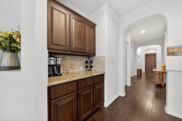 5001 Shadybrook Rd, Midland, TX 79705 - bar featuring arched walkways, dark wood finished floors, decorative backsplash, baseboards, and recessed lighting