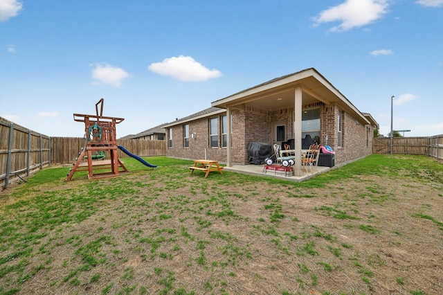 5001 Shadybrook Rd, Midland, TX 79705 - back of property featuring brick siding, a patio area, and a playground
