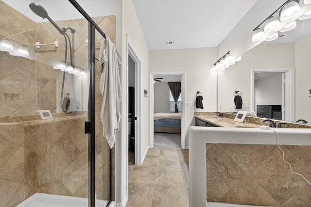 5001 Shadybrook Rd, Midland, TX 79705 - ensuite bathroom featuring a shower stall, double vanity, and stone finish floors