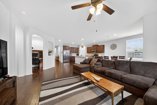 5001 Shadybrook Rd, Midland, TX 79705 - living room featuring dark wood-style flooring, arched walkways, a ceiling fan, and recessed lighting