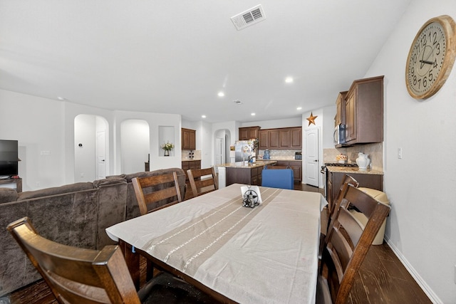 5001 Shadybrook Rd, Midland, TX 79705 - dining space featuring arched walkways, recessed lighting, and baseboards
