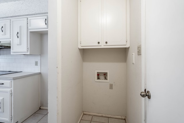 laundry room with hookup for a washing machine, cabinet space, and light tile patterned floors