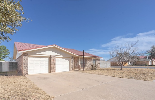 ranch-style home with an attached garage, fence, concrete driveway, and brick siding