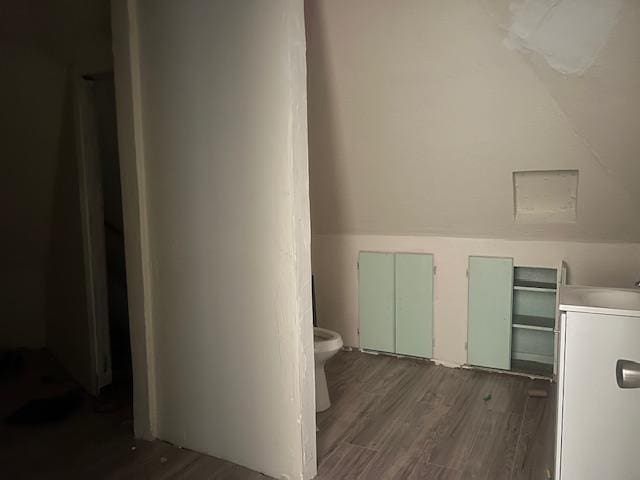 2508 22nd St, Snyder, TX 79549 - bathroom with toilet, washer / clothes dryer, and wood finished floors